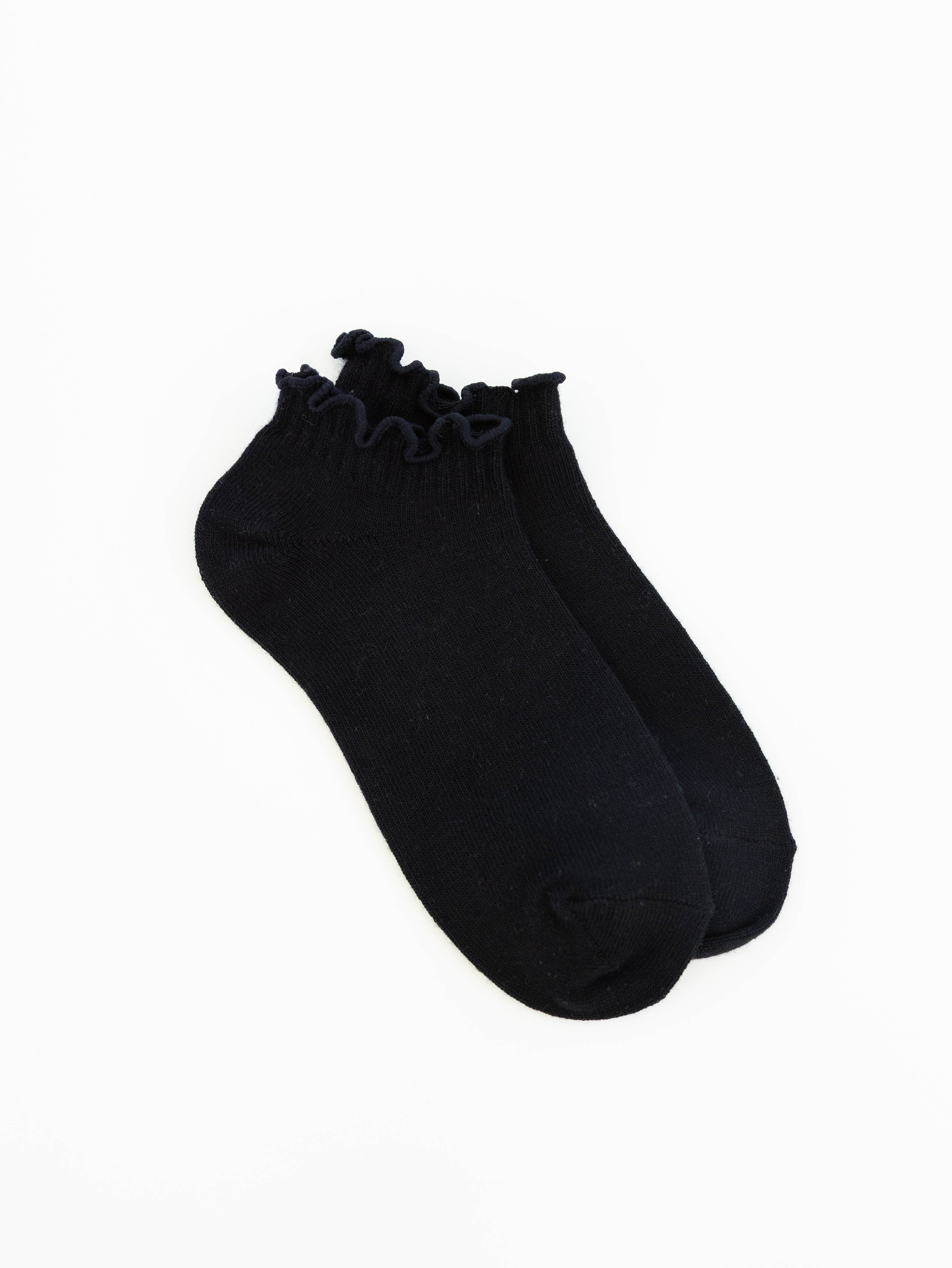 Women's black low-cut socks featuring a soft ruffle cuff made from a lightweight modal blend for everyday comfort.