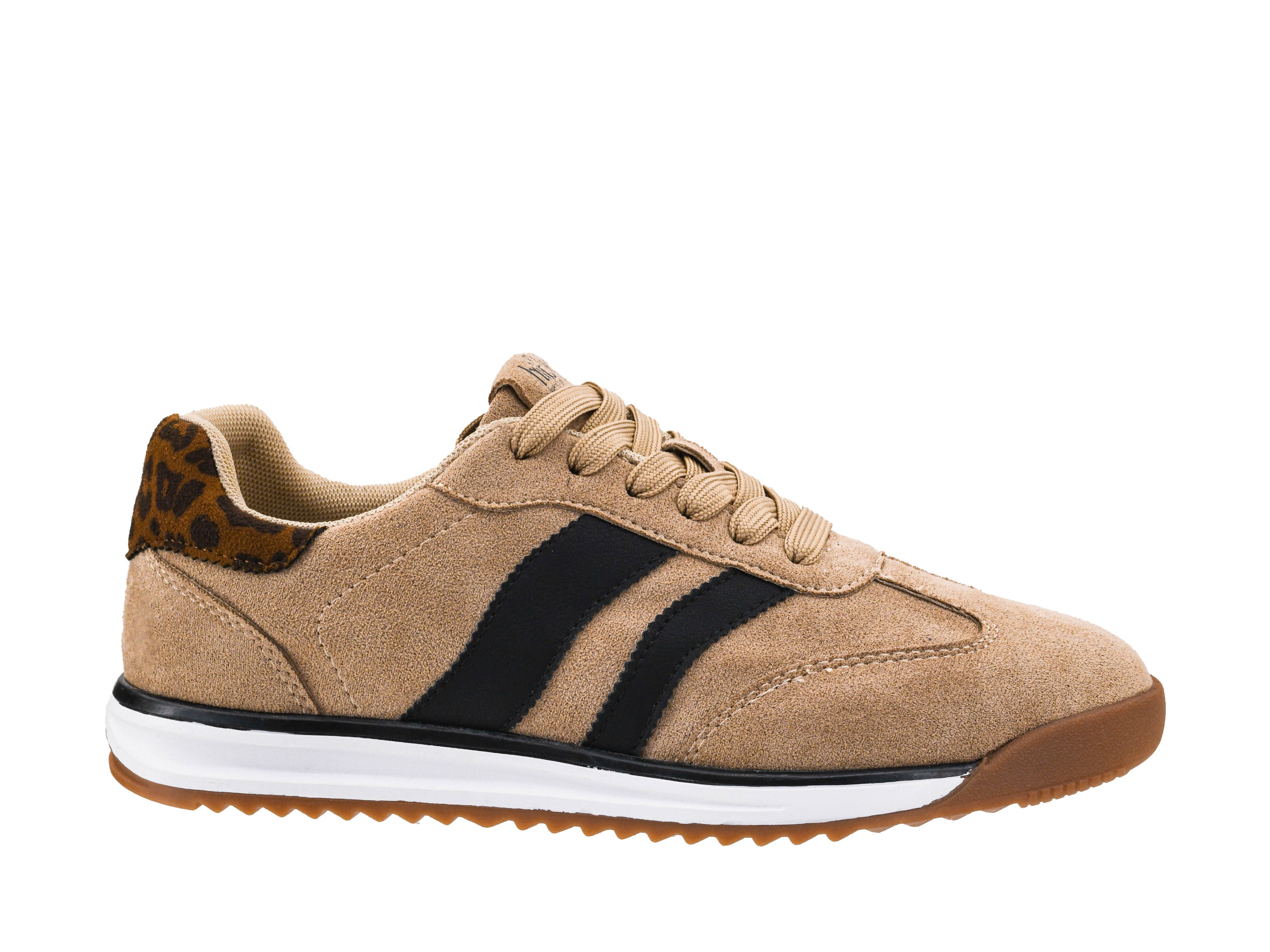 Beige sneaker with black stripes on a white background
