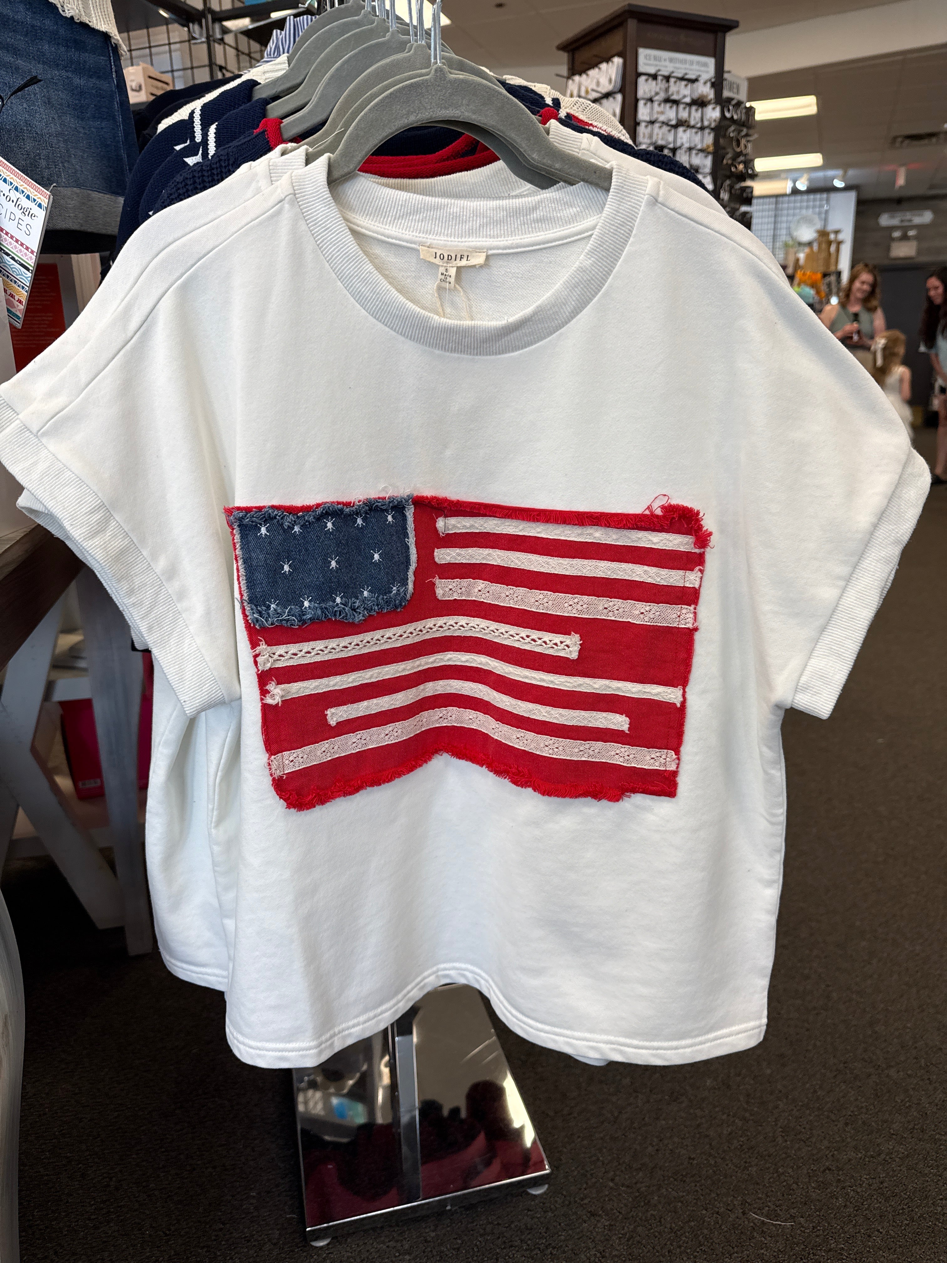 white short sleeve top with frayed American flag patch detail
