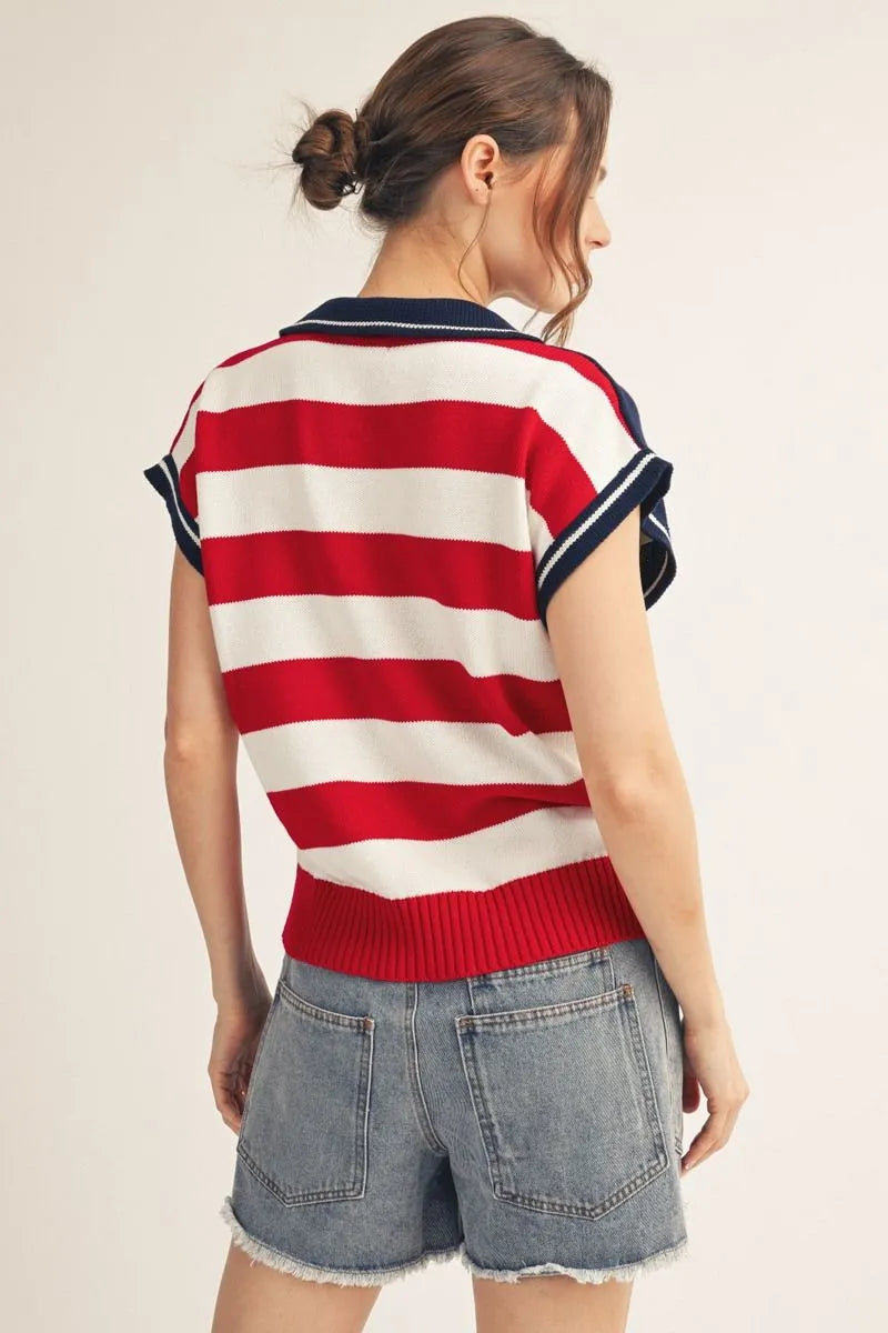 woman wearing American flag sweater polo top with embroidered stars and denim shorts back view