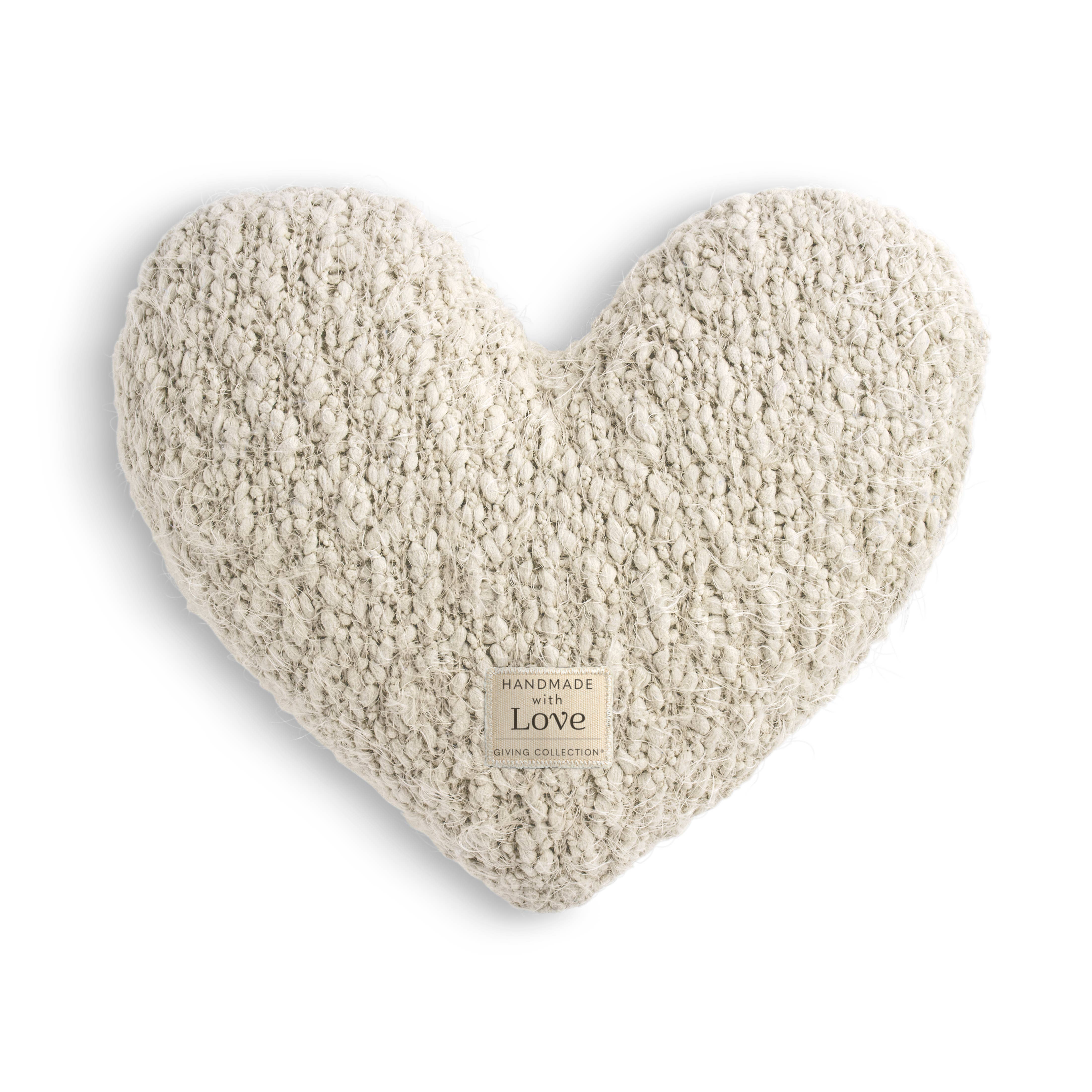 DEMDACO Cream Giving Heart Weighted Pillow — heart-shaped pillow in chunky cream boucléknit yarn with a "Handmade with Love — Giving Collection" woven label, photographed on a white background