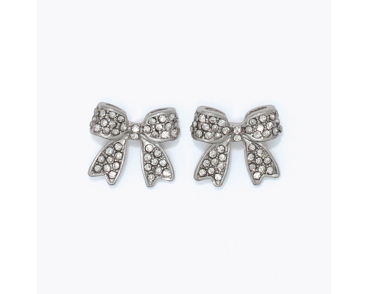 Fully pavé crystal-encrusted silver-tone bow stud earrings by Periwinkle — sparkling clear crystal bow studs in a feminine, on-trend design