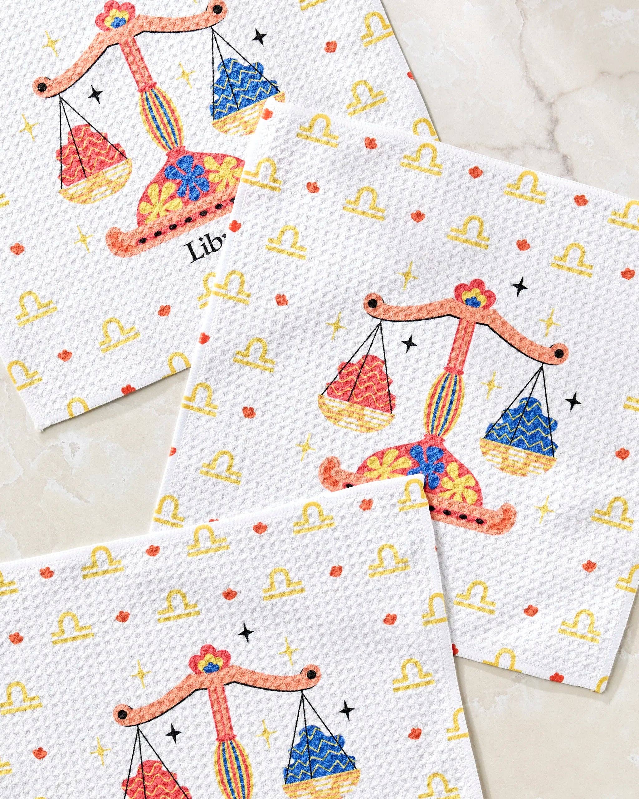 Close-up view of Geometry Charming Libra dishcloth set featuring zodiac-inspired Libra scales design reusable kitchen cloths