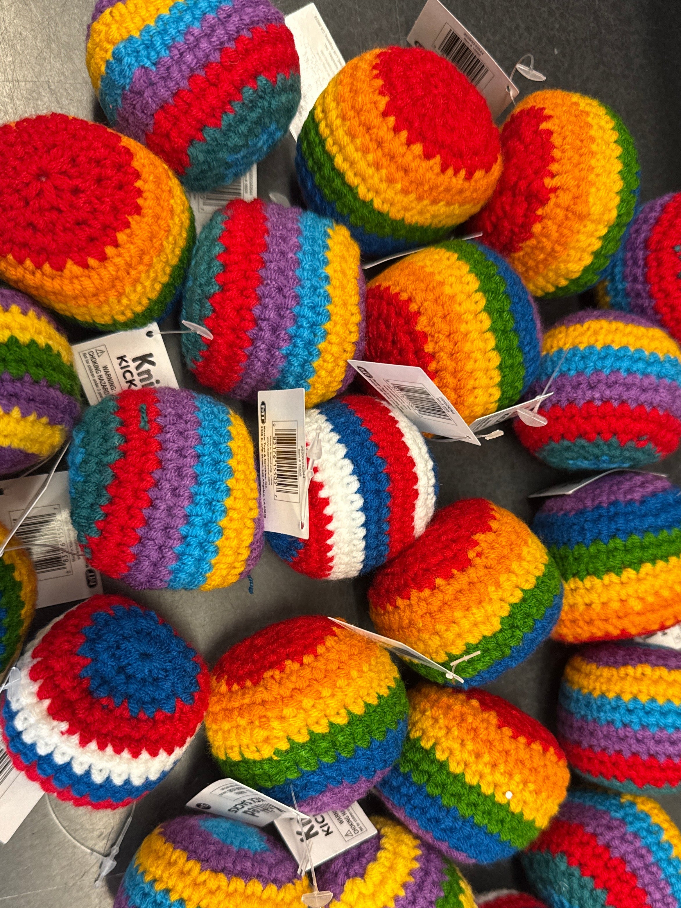 Colorful handcrafted knit kick sacks with crochet design for active outdoor play, coordination practice, and family fun.