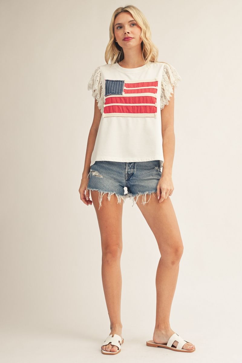 woman wearing off white patriotic top with lace flutter sleeves and American flag patch