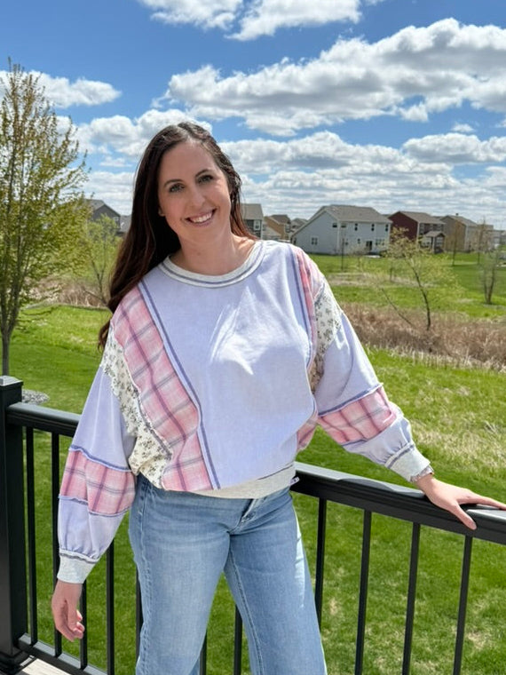 Woman wearing lavender mixed fabric mineral washed oversized dolman sweatshirt top