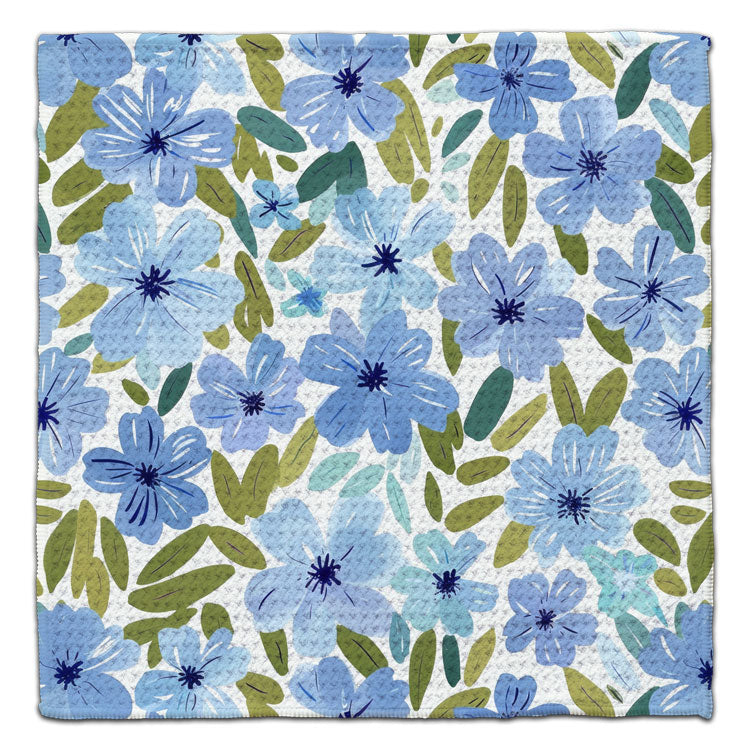 Light Blue Blooms eco-friendly waffle weave washcloth featuring watercolor blue flowers and green leaves on a white background.