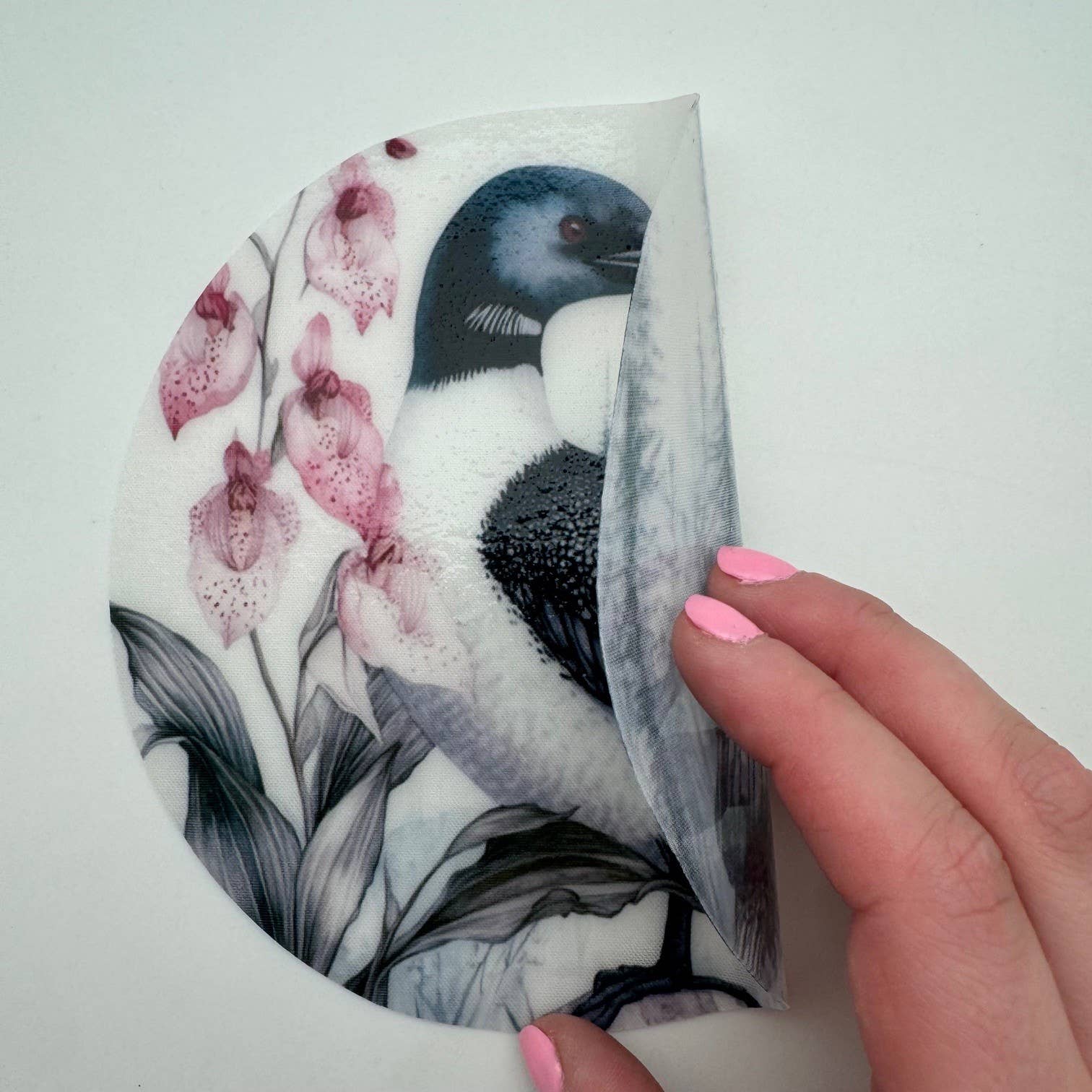 Silicone jar opener featuring Minnesota loon bird and lady slipper flower design