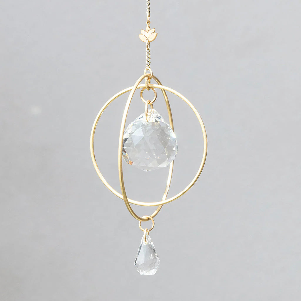 Scout Curated Wears Lotus Strength mini crystal suncatcher featuring gold-plated brass design and crystal prisms creating rainbow reflections