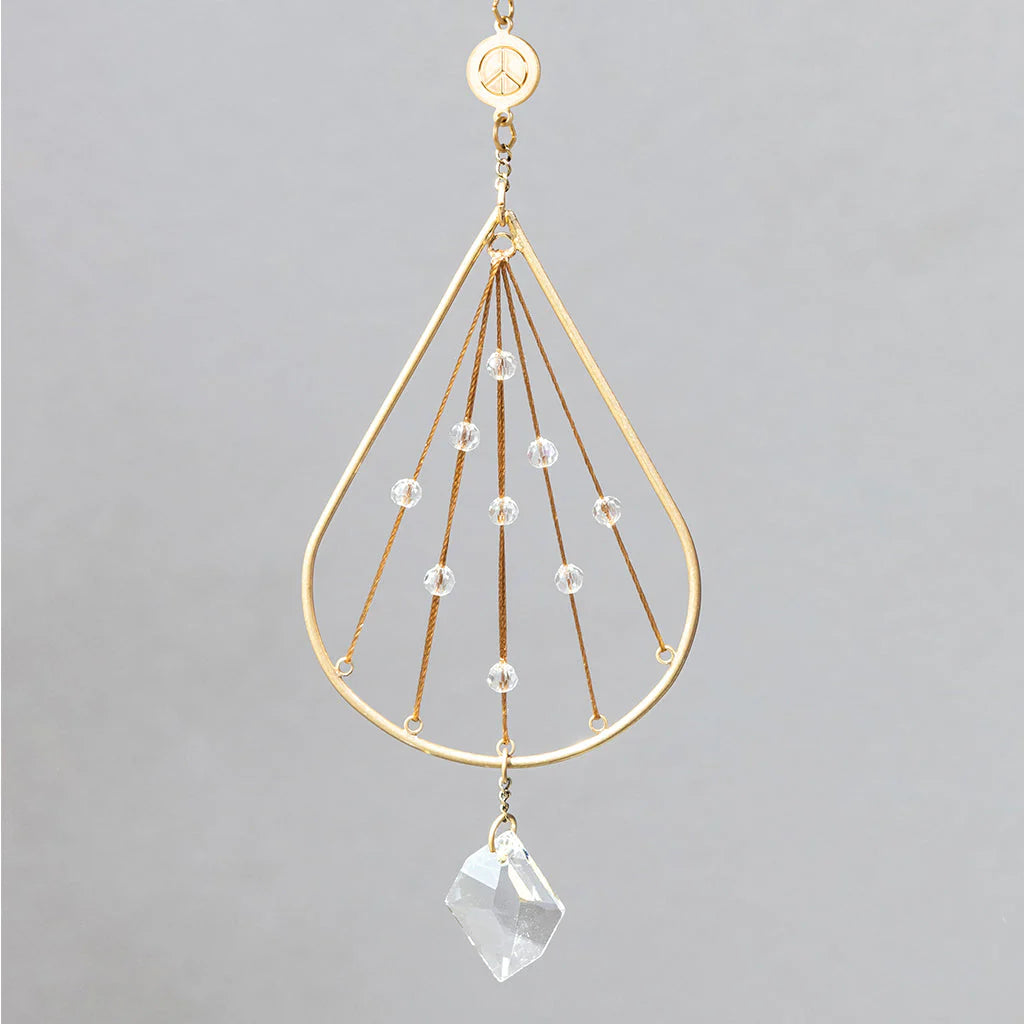 Scout Curated Wears Peace Tranquility mini crystal suncatcher featuring gold-plated brass design with crystal prism and rainbow reflections