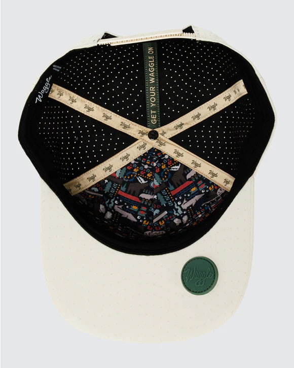 inside view of tan Waggle repel hat with wolf forest graphic and perforated panels