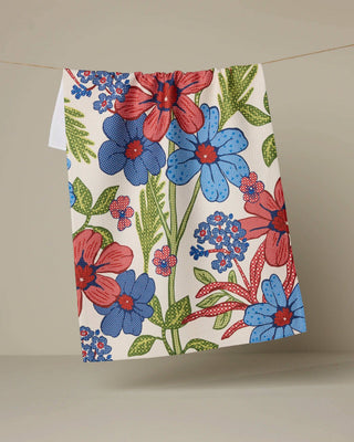 Floral patterned towel with red and blue flowers on a beige background
