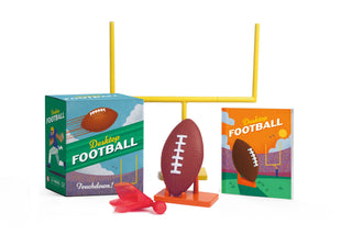 Desktop football game set with packaging and miniature football and goalpost on a white background