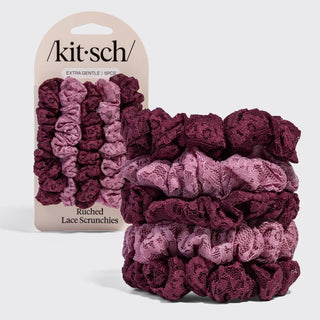A set of five Kit-Sch ruched lace scrunchies in a vertical color gradient from light pink to deep burgundy, shown with the retail packaging on a light gray background.