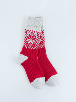 World's Softest red and white patterned sock on a light gray background
