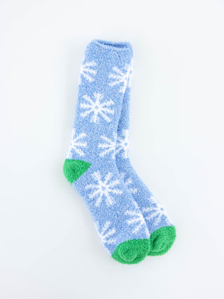 World's Softest women's blue socks with white snowflake patterns and green toes on a light gray background