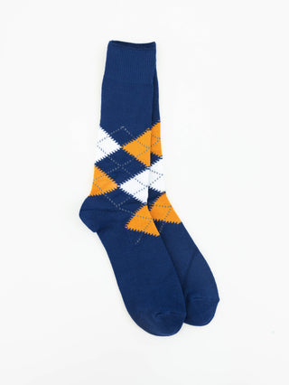 A pair of 1902 navy blue crew socks with an argyle pattern in white and orange, displayed against a plain white background.