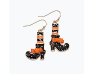 A pair of dangling witch boot earrings with black glitter enameled boots, orange stripes, orange bows, and gold-tone hooks on a white background.