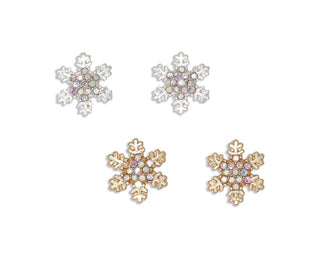 Snowflake-shaped stud earrings on a plain white background, including two silver-toned and two gold-toned pairs with iridescent and clear crystals.