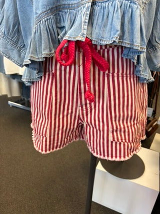 Red and white striped shorts with a denim top on a mannequin.