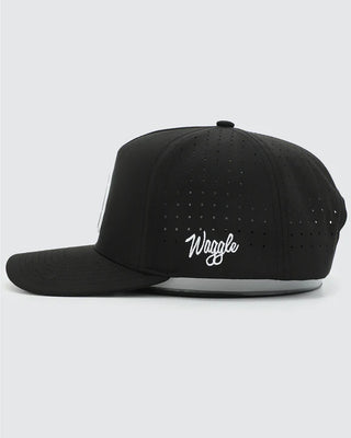 Left side view of Waggle Frost Bite Snapback in black — perforated breathable panels with Waggle script embroidery
