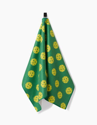 Green towel with yellow pattern hanging on a white background