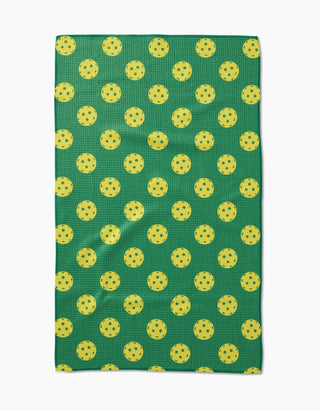 Geometry Pickleball Tea Towel flat lay showing green background with all-over yellow pickleball print, 18x30 eco-friendly kitchen towel