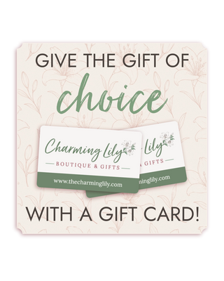 Promotional graphic for a gift card package reading 'GIVE THE GIFT OF choice WITH A GIFT CARD!' with two sample Charming Lily Boutique & Gifts gift cards shown in the center on a pale cream background with faint floral line art.