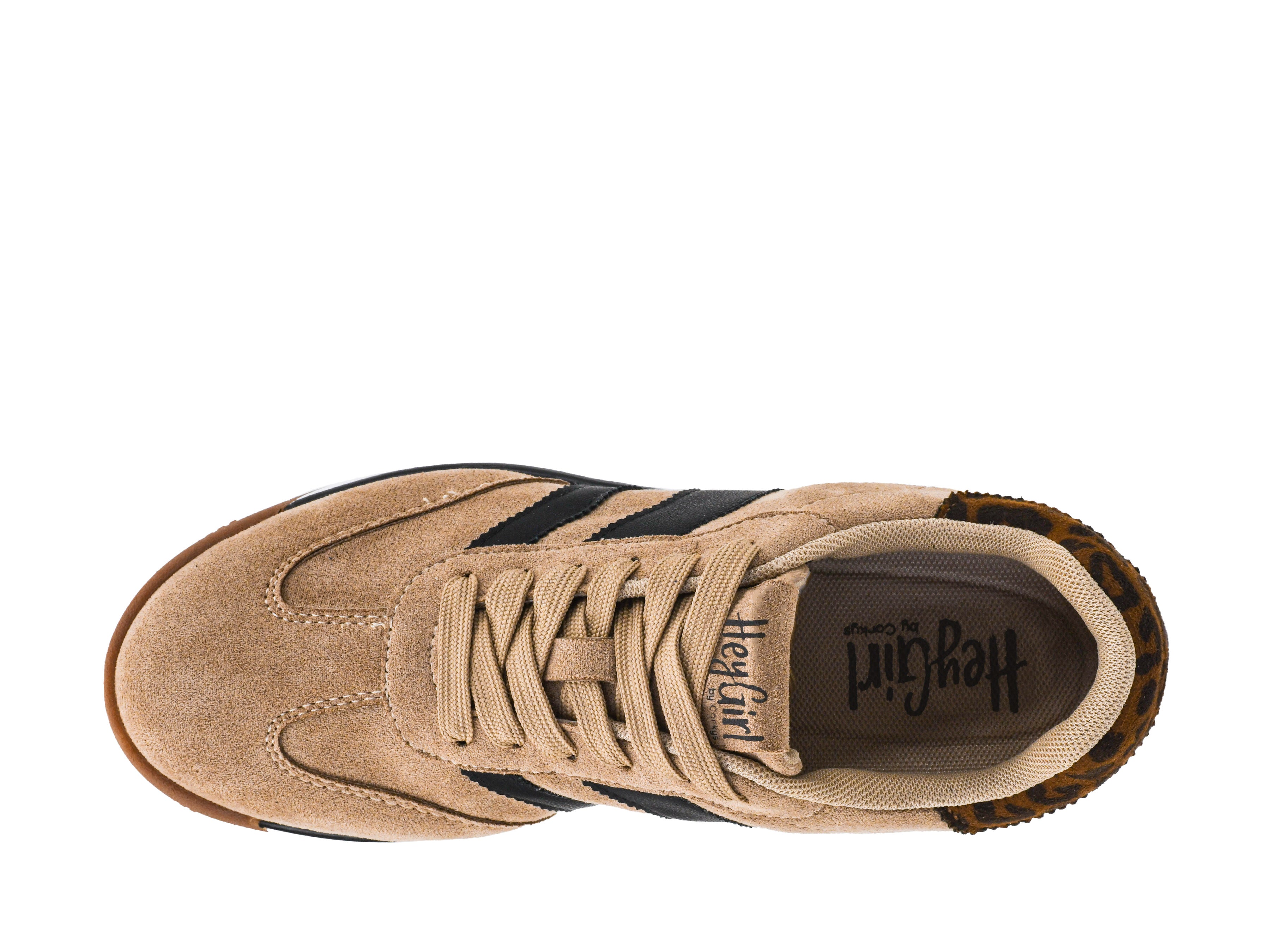 Tan sneaker with black stripes on a white background