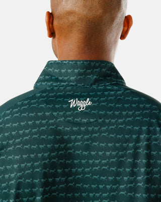Close-up of Waggle script logo on teal stag-print quarter zip pullover collar — men's golf apparel