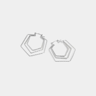 Pair of silver hoop earrings on a light gray background