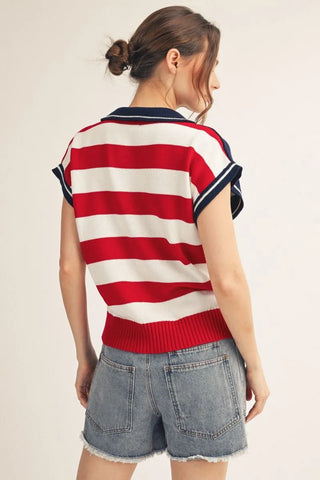 woman wearing American flag sweater polo top with embroidered stars and denim shorts back view