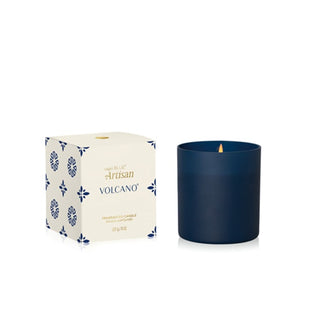 Blue candle with 'Artisan Volcano' packaging on a white background