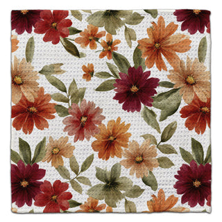 Autumn Colorful Daisies eco-friendly washcloth with floral pattern of red, orange, and green flowers on a white background
