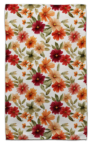 Floral patterned towel with red, orange, and green flowers on a white background