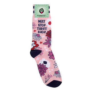 A single pink crew sock with a floral pattern and the text 'NEXT STOP THRIFT SHOP' printed on it, shown with its green Funatic brand tag at the top against a plain white background.