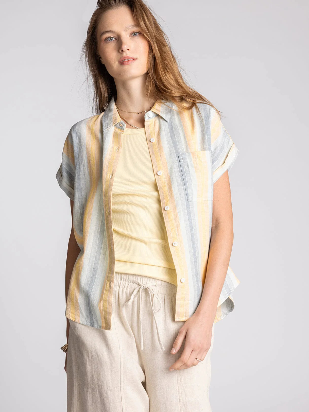 Woman wearing Benny striped linen blend button-up shirt with soft multicolor vertical stripes