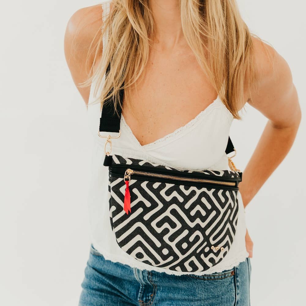 Woman wearing Callahan canvas bum bag in black and cream geometric print crossbody style