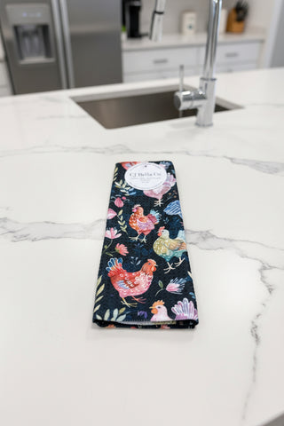 Eco-friendly waffle weave washcloth featuring colorful watercolor chickens and wildflowers on a navy blue background.