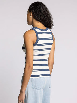 woman wearing fitted white and indigo striped ribbed tank top with contrast trim back view