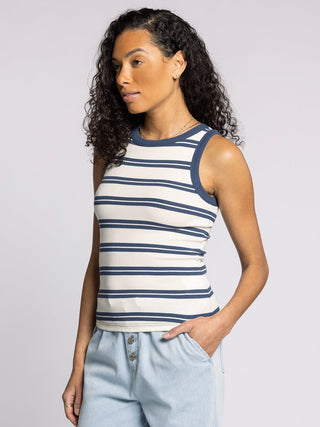 woman wearing fitted white and indigo striped ribbed tank top with contrast trim