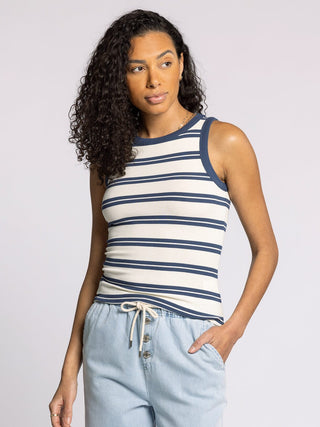woman wearing fitted white and indigo striped ribbed tank top with contrast trim