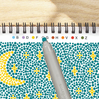 FlowArt sample page with a pattern of colored dots and a pen on a wooden surface