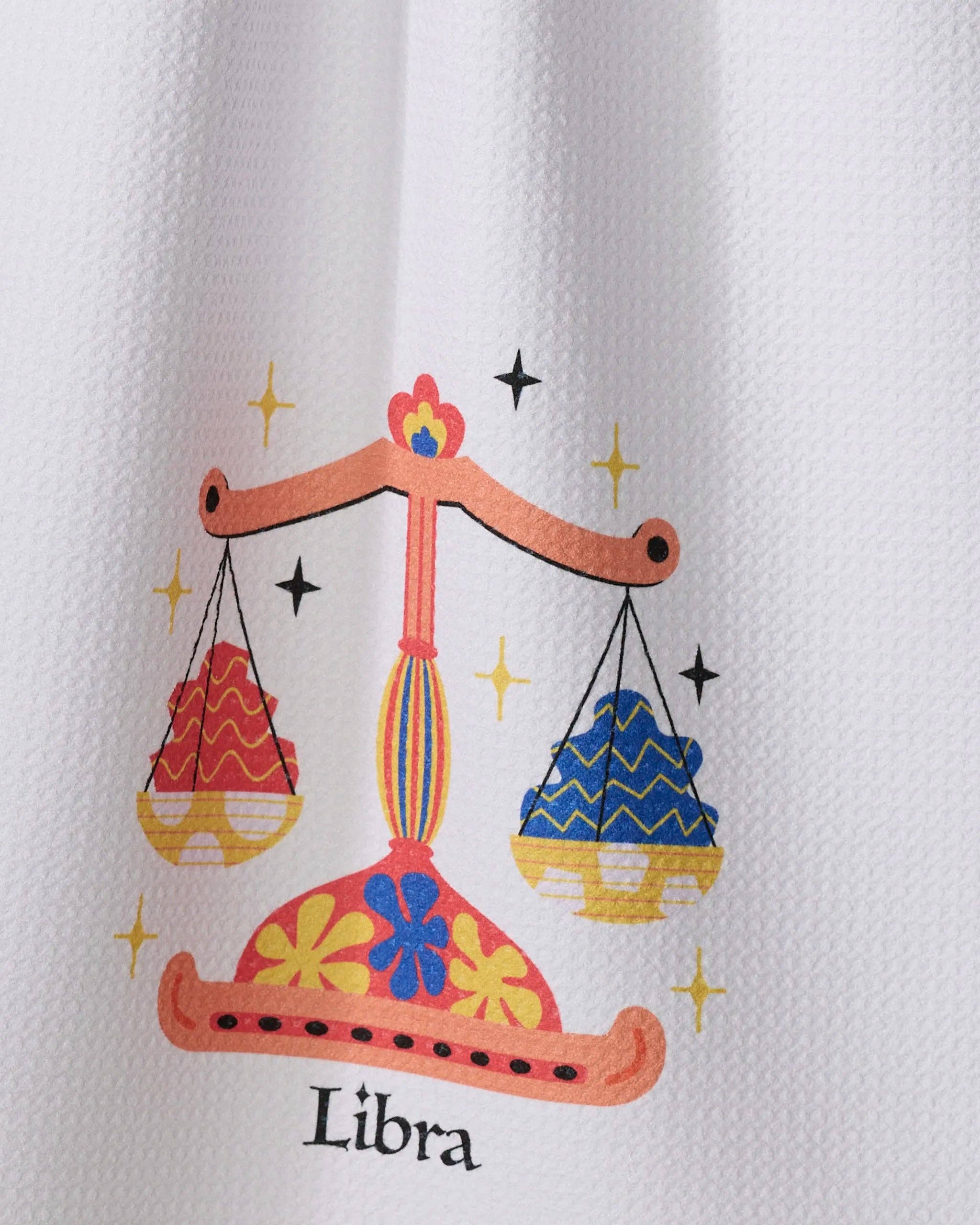 Geometry Charming Libra tea towel with zodiac-inspired Libra scales design hanging kitchen towel close up