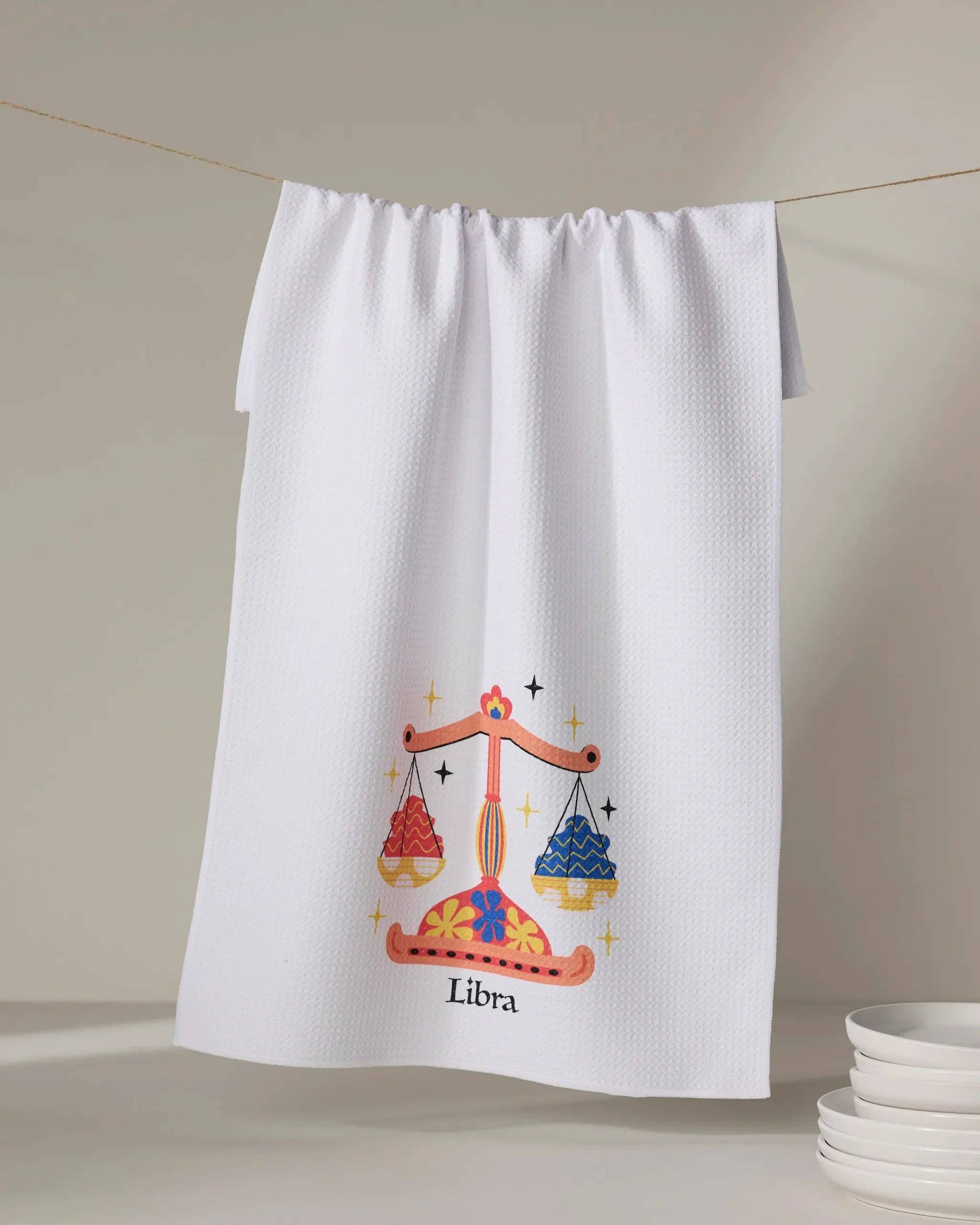 Geometry Charming Libra tea towel with zodiac-inspired Libra scales design hanging kitchen towel