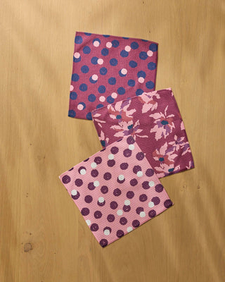 Geometry Mulberry Bloom Dot Dishcloth Set 3-pack flat lay on wood surface showing coordinating dot, floral bloom, and blush polka dot prints in mulberry pink tones