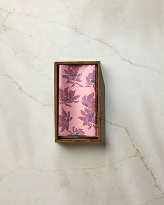 Geometry Mulberry Bloom Not Paper Towel displayed in a wood countertop holder on white marble, showing full blush pink and mulberry floral print — eco-friendly reusable paper towel