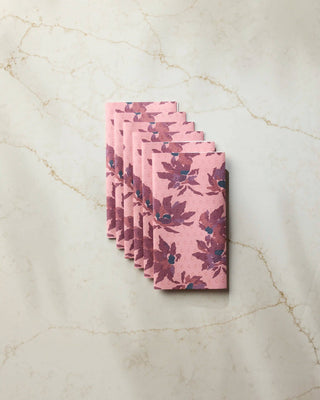 Geometry Mulberry Bloom Not Paper Towel set of 6 fanned out on white marble surface showing blush pink background with deep mulberry and teal floral bloom print