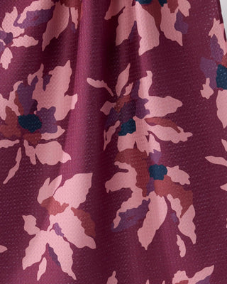 Close-up of Geometry Mulberry Bloom Tea Towel showing Geoweave™ texture with painterly blush pink and teal floral pattern on rich mulberry recycled polyester fabric