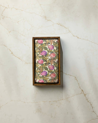 Geometry Wild Fig Not Paper Towel displayed in a dark wood countertop holder on white marble, showing full botanical wild fig print with purple and pink figs — eco-friendly reusable paper towel